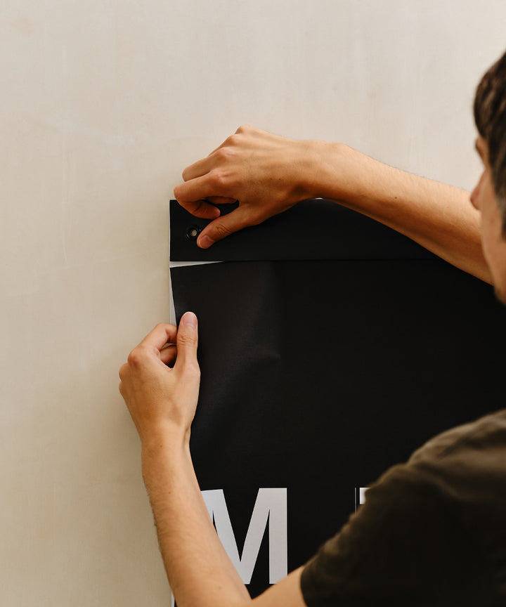 Hold the header steady with one hand, and start a small tear of about 1 cm / ½″ along the perforation